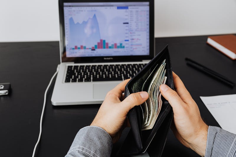pulling cash from a wallet
